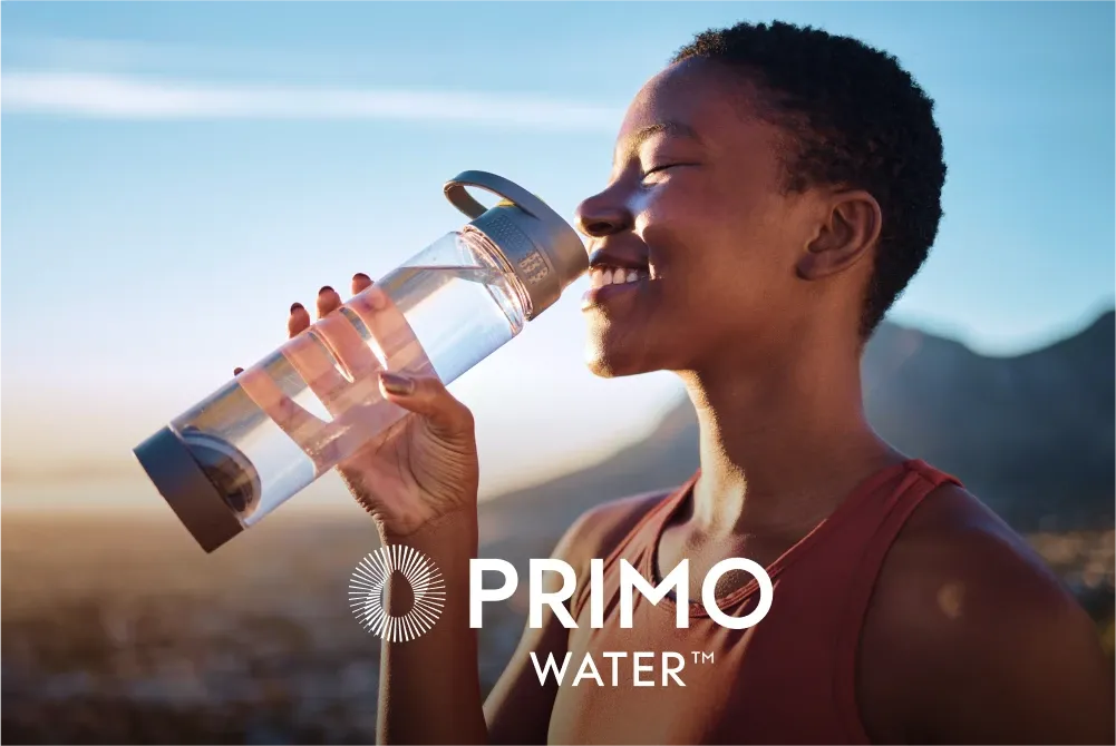 Woman drinking from water bottle with Primo Water logo