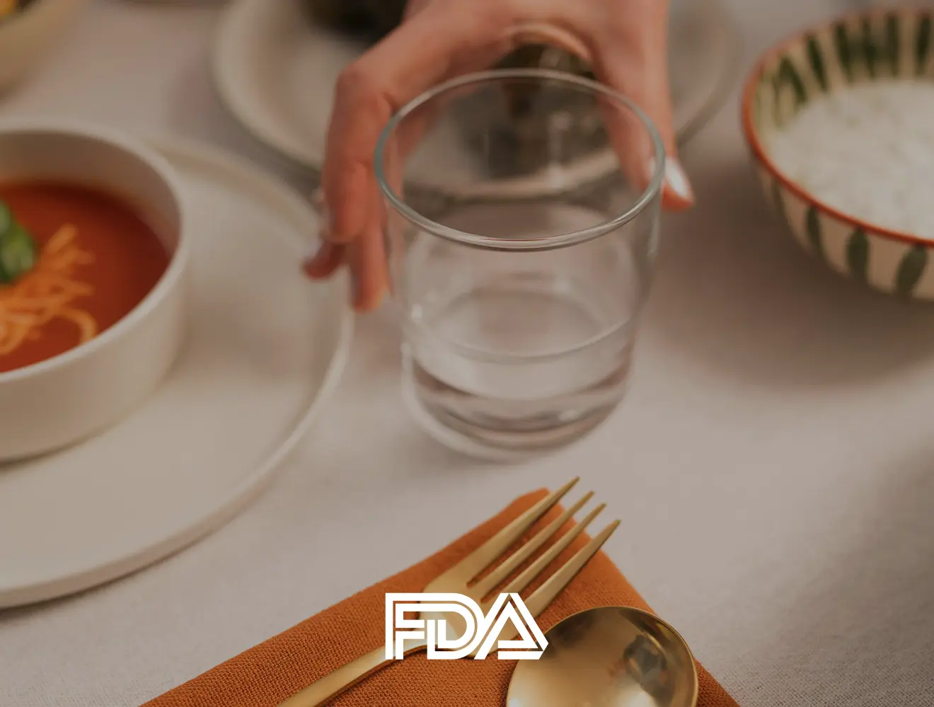 Glass of water on table with FDA logo