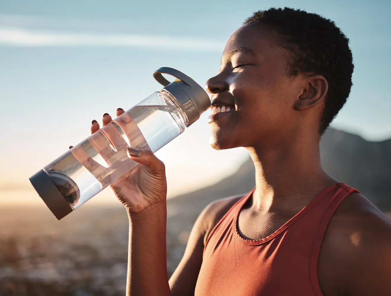 Woman drinking from water bottle