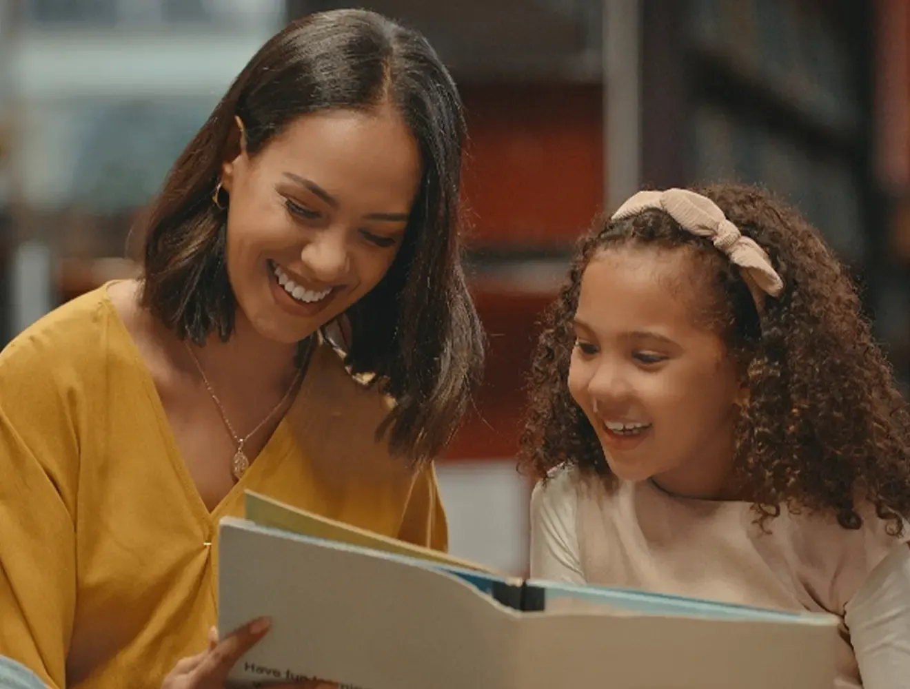 Woman reading a book to a girl