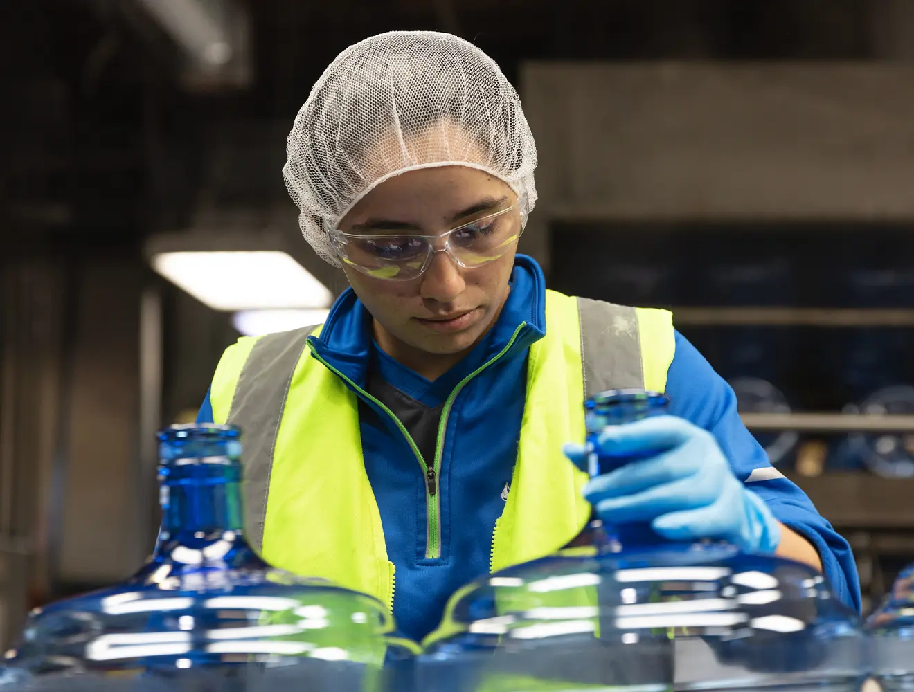 Woman cleaning and sanitizing Primo Water Bottles for reuse