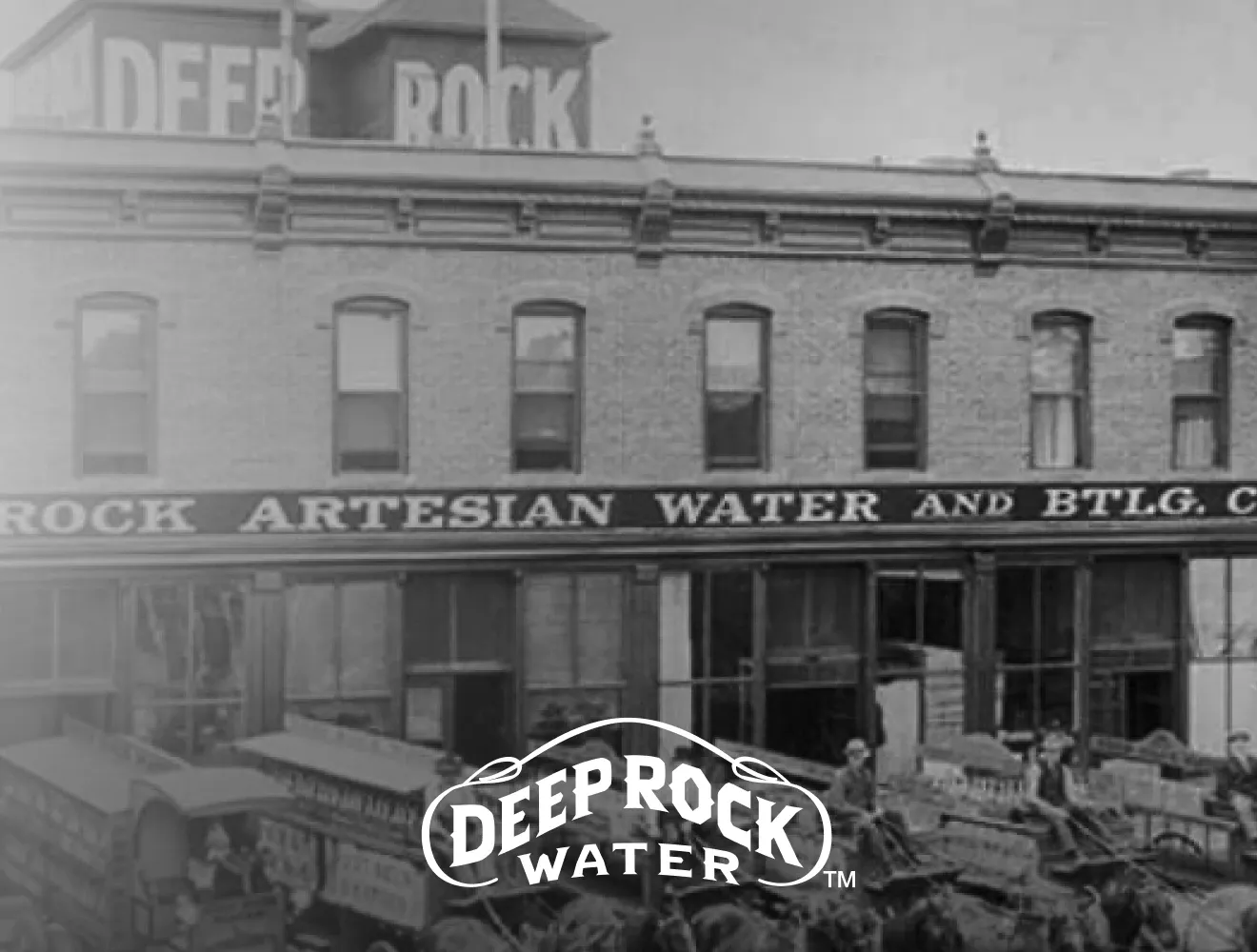 Black & white image of old Deep Rock Artesian Water and Btlg Company brick building with Deep Rock Water logo