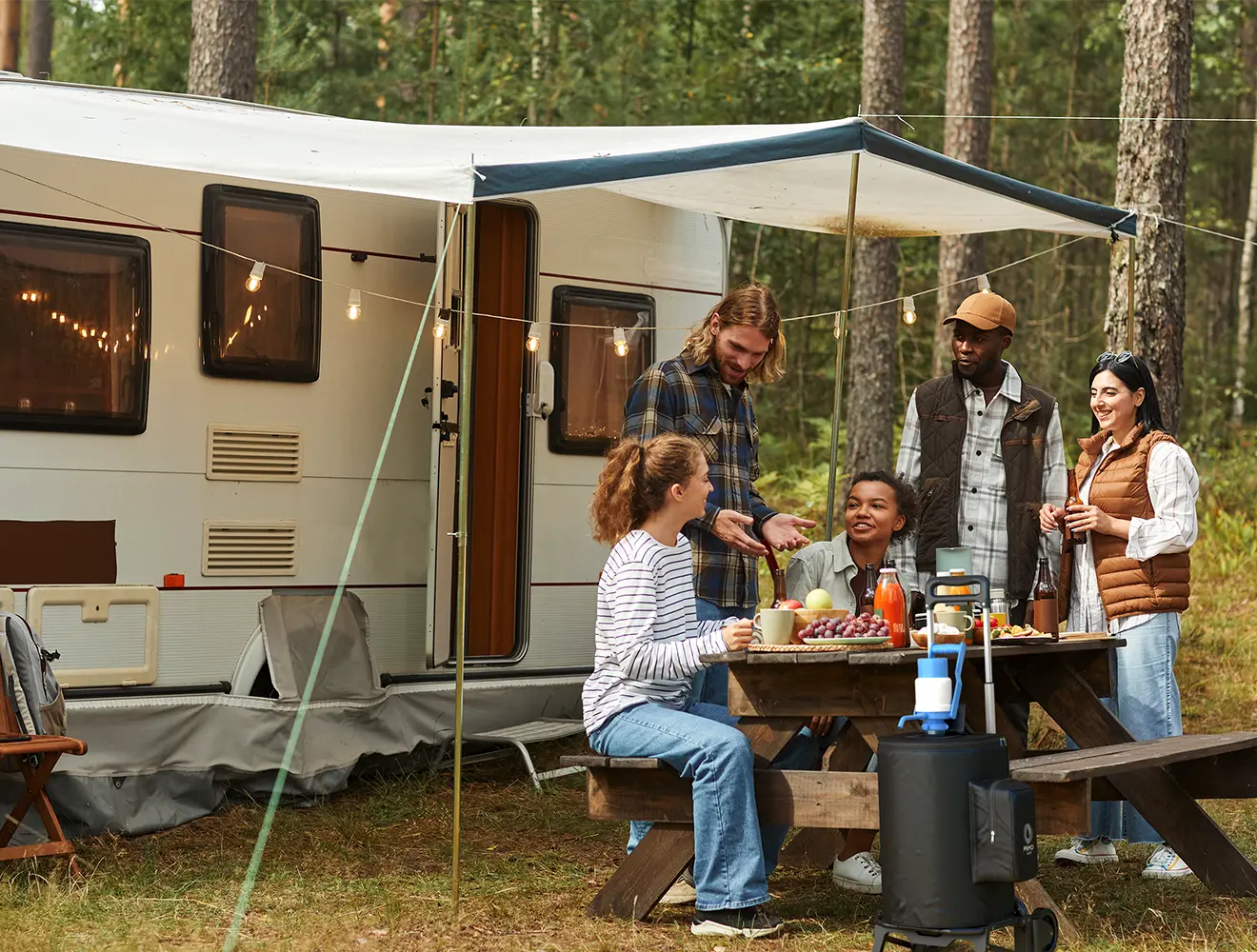 A group enjoying an Primo Outdoor Water Dispenser