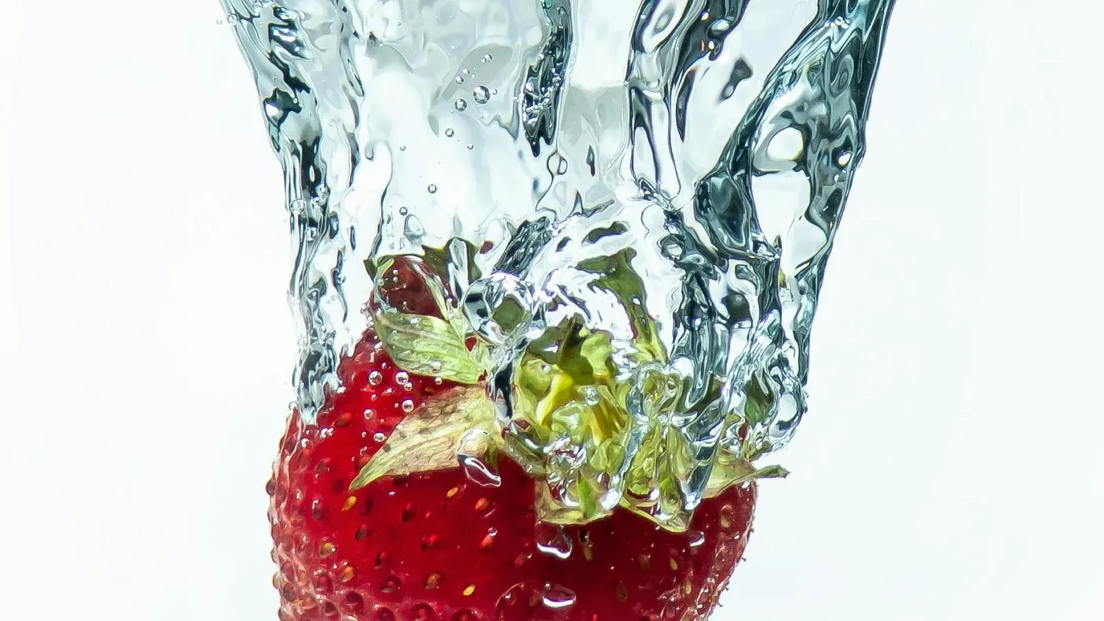 A strawberry dropped into water